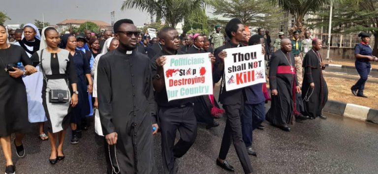 Catholic bishops in Nigeria lead a peaceful protest; Father Sebastain Sanni holds a placard saying “Thou shall not kill” during the march (Credit: Aid to the Church in Need)