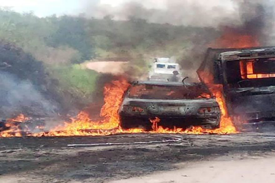 With image of burnt-out car in Butembo-Beni Diocese (© Aid to the Church in Need)