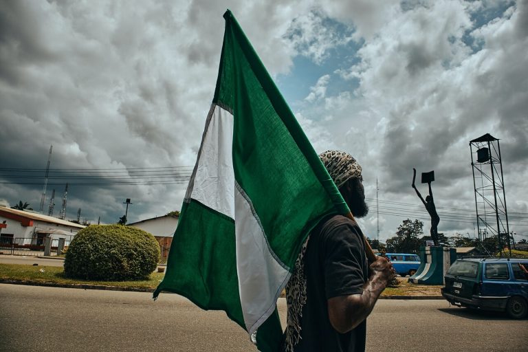 A man with a Nigerian flag in Port Harcourt, Nigeria. (© Emmanuel Ikwuegbu)